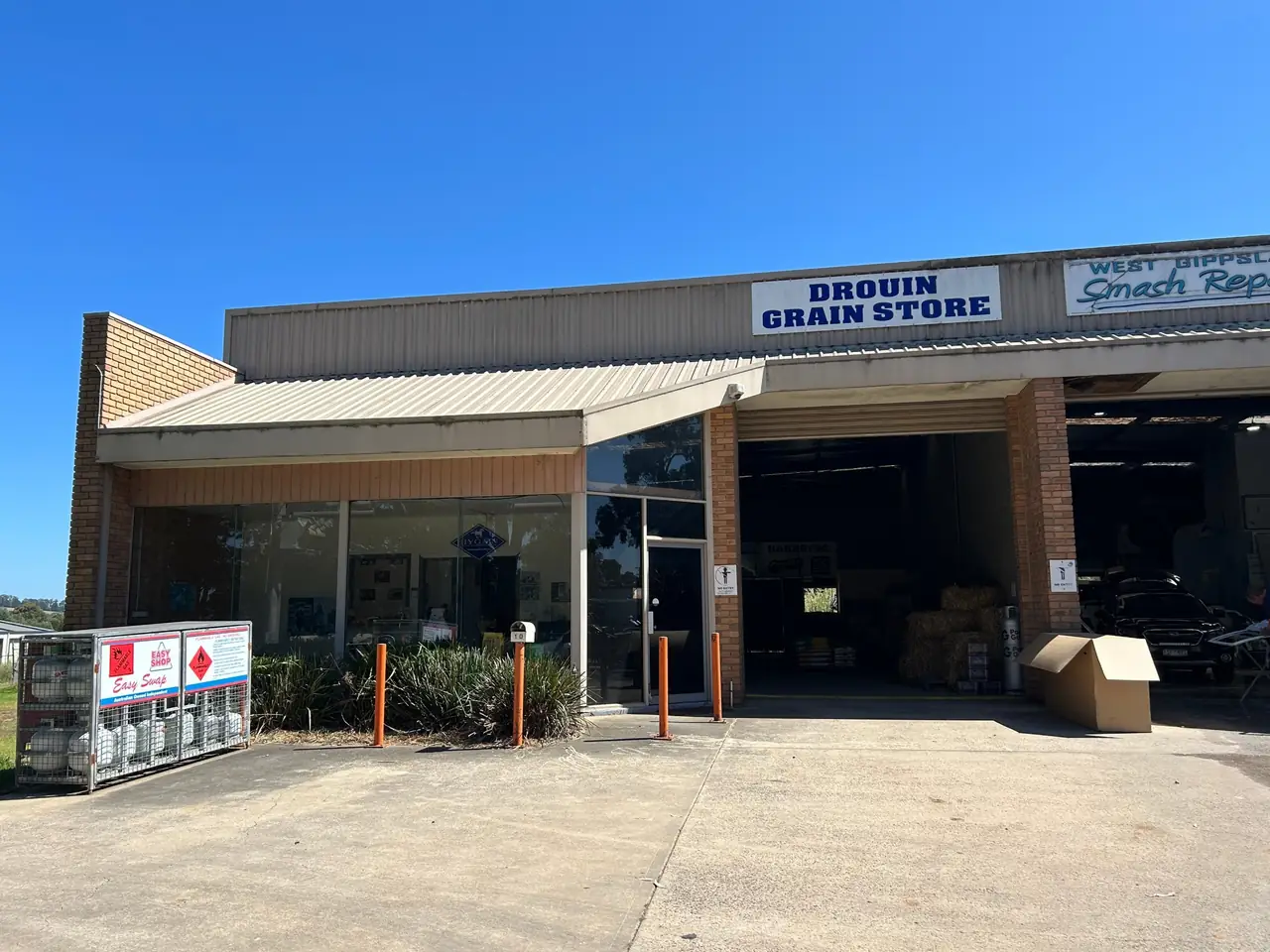 The Drouin Grain Store shopfront at 10 Roberts Ct, Drouin, with its blue and white sign